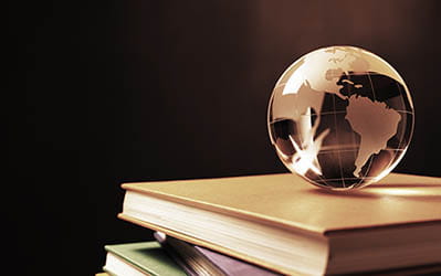 globe of the world on a stack of books