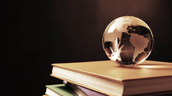 globe of the world on a stack of books